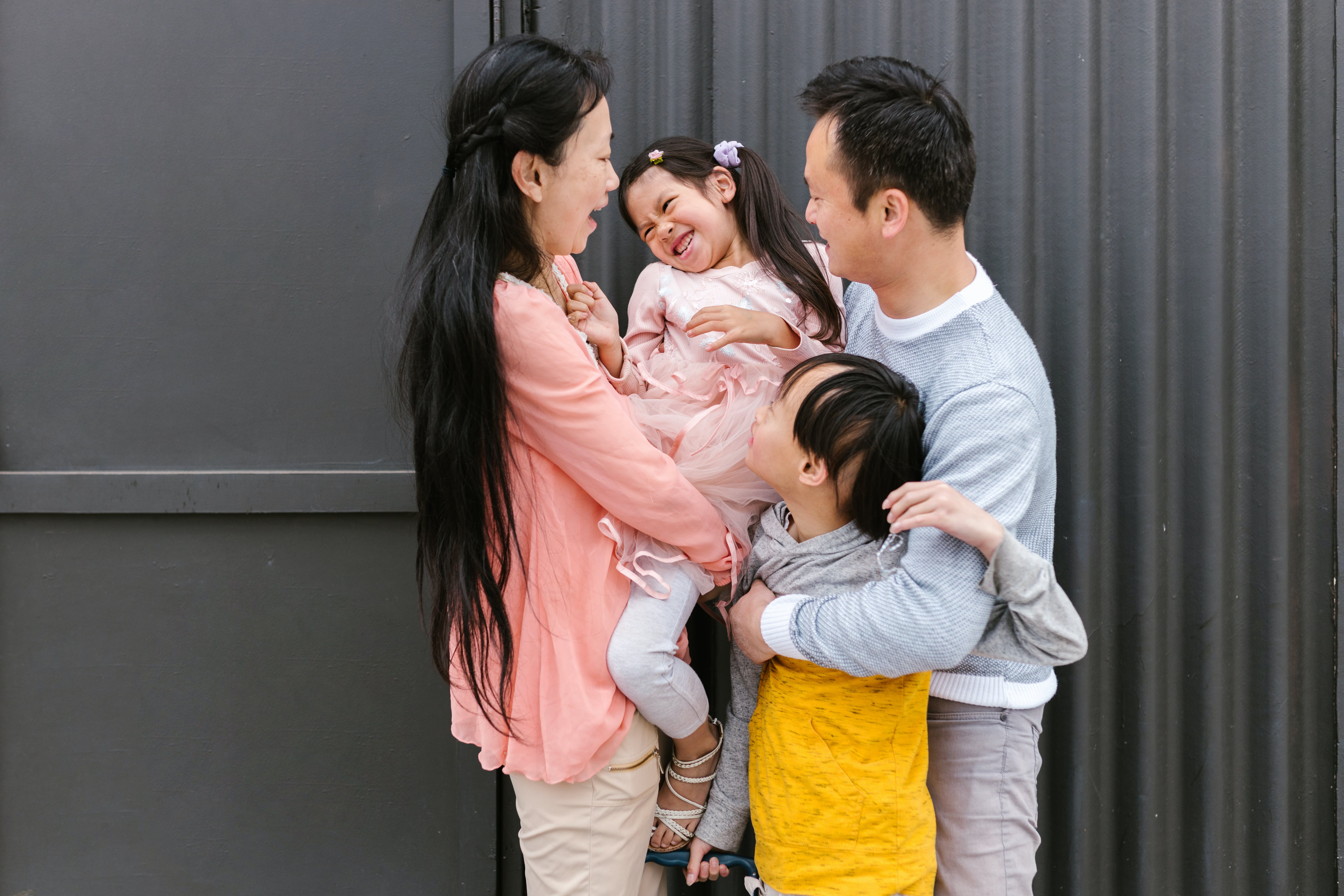 An image depicting a family scene where parents are comforting and supporting their child with ADHD. The parents are shown embracing their child, providing care and understanding. The child appears comforted within the family's embrace, reflecting a supportive environment for a child dealing with ADHD.